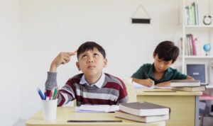 asian-student-boy-thinking-exam-classroom_368093-1767